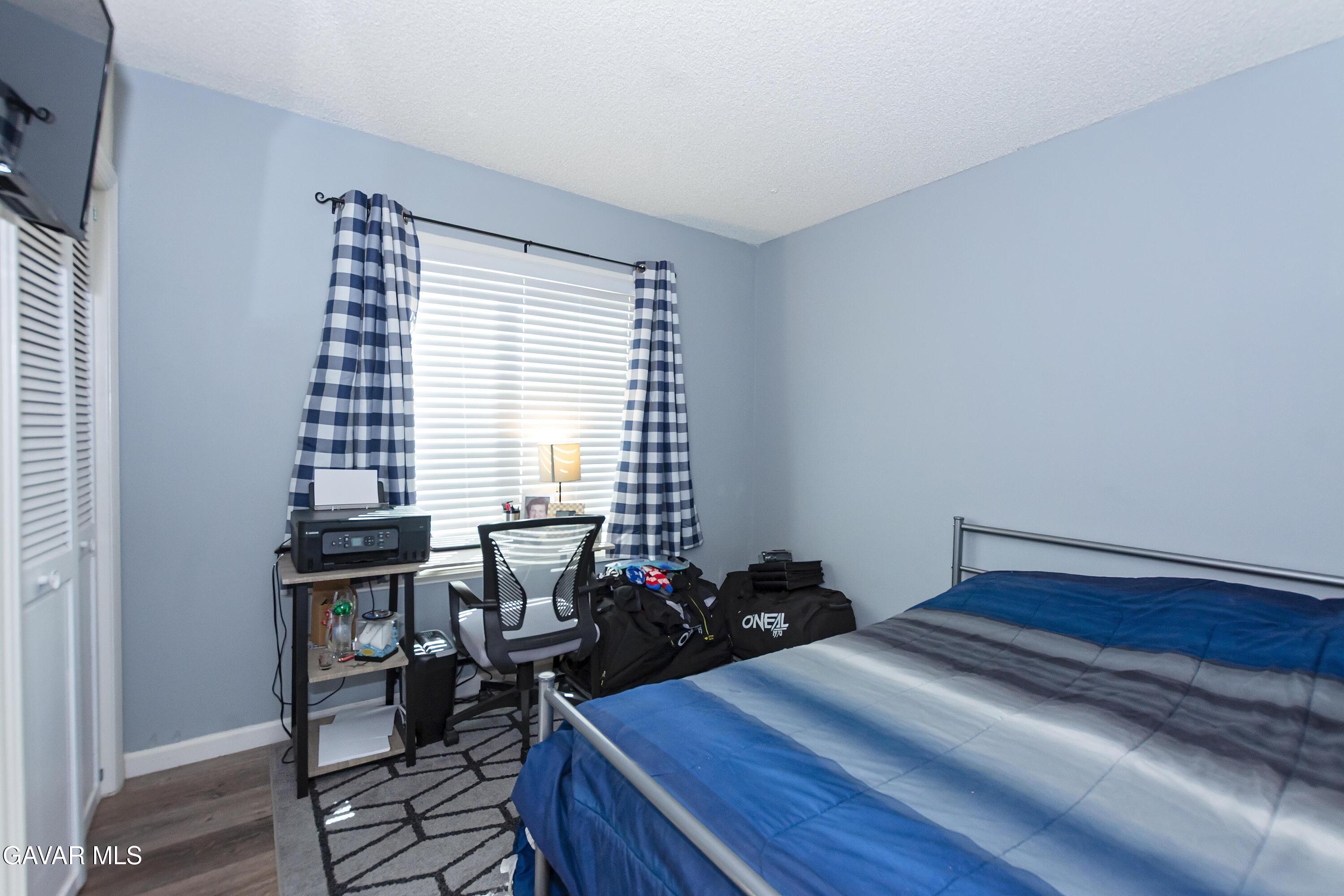 42933 Alexo Drive Lancaster, CA 93536 - Photo 25 of 32 a bed room with a bed and a chair