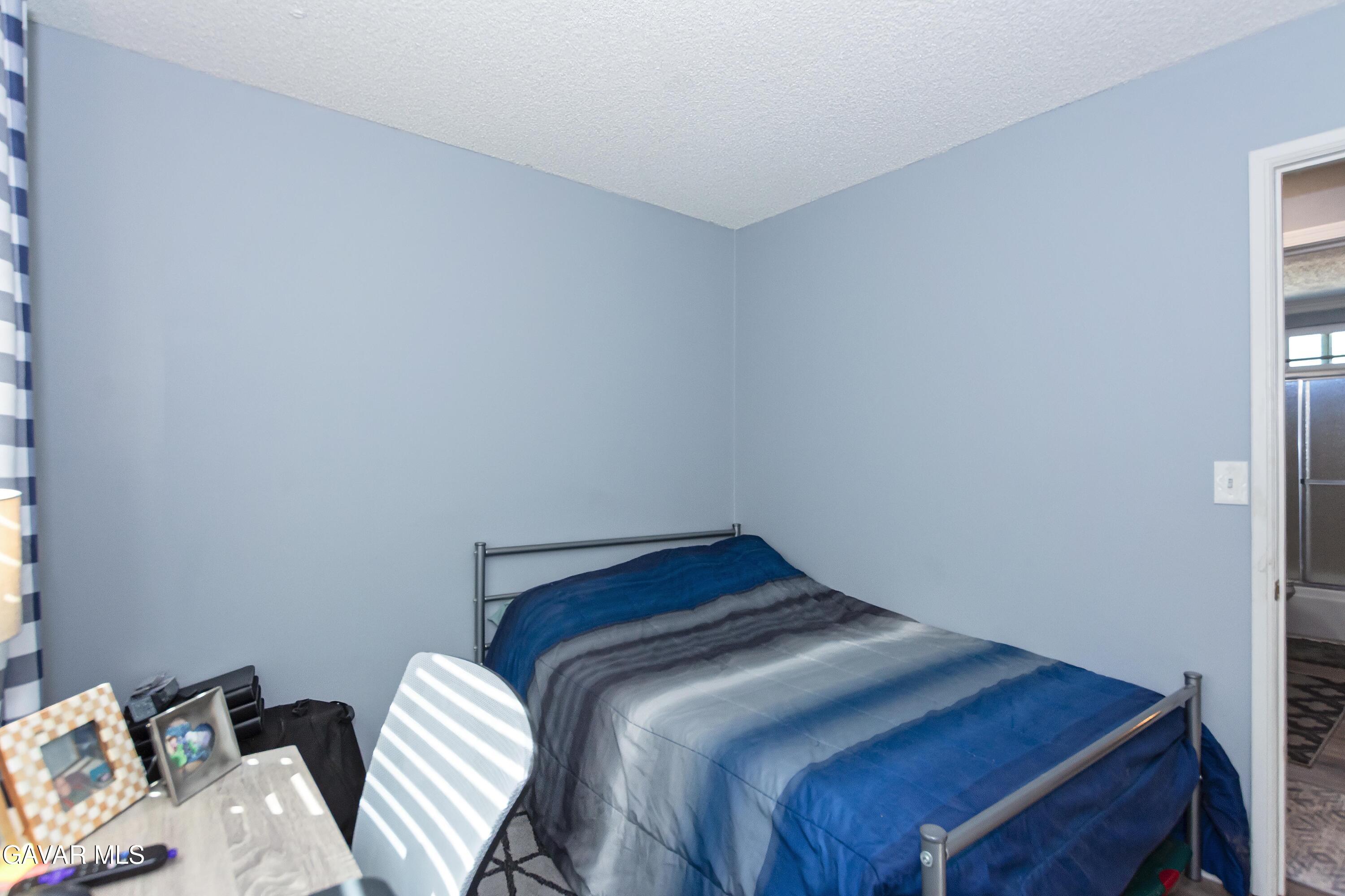42933 Alexo Drive Lancaster, CA 93536 - Photo 26 of 32 a bedroom with a bed and a bed