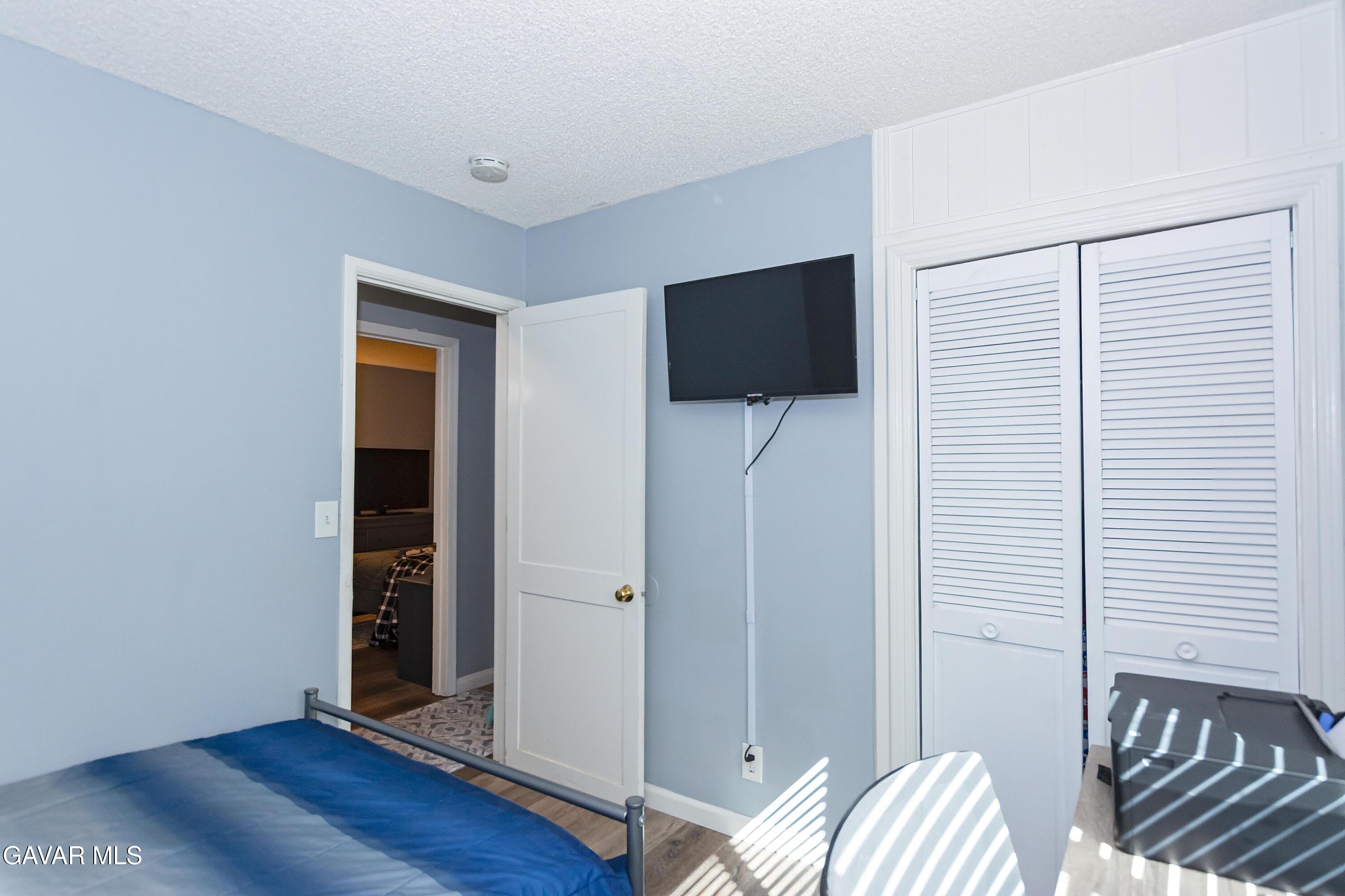 42933 Alexo Drive Lancaster, CA 93536 - Photo 27 of 32 a view of a livingroom with wooden floor and closet