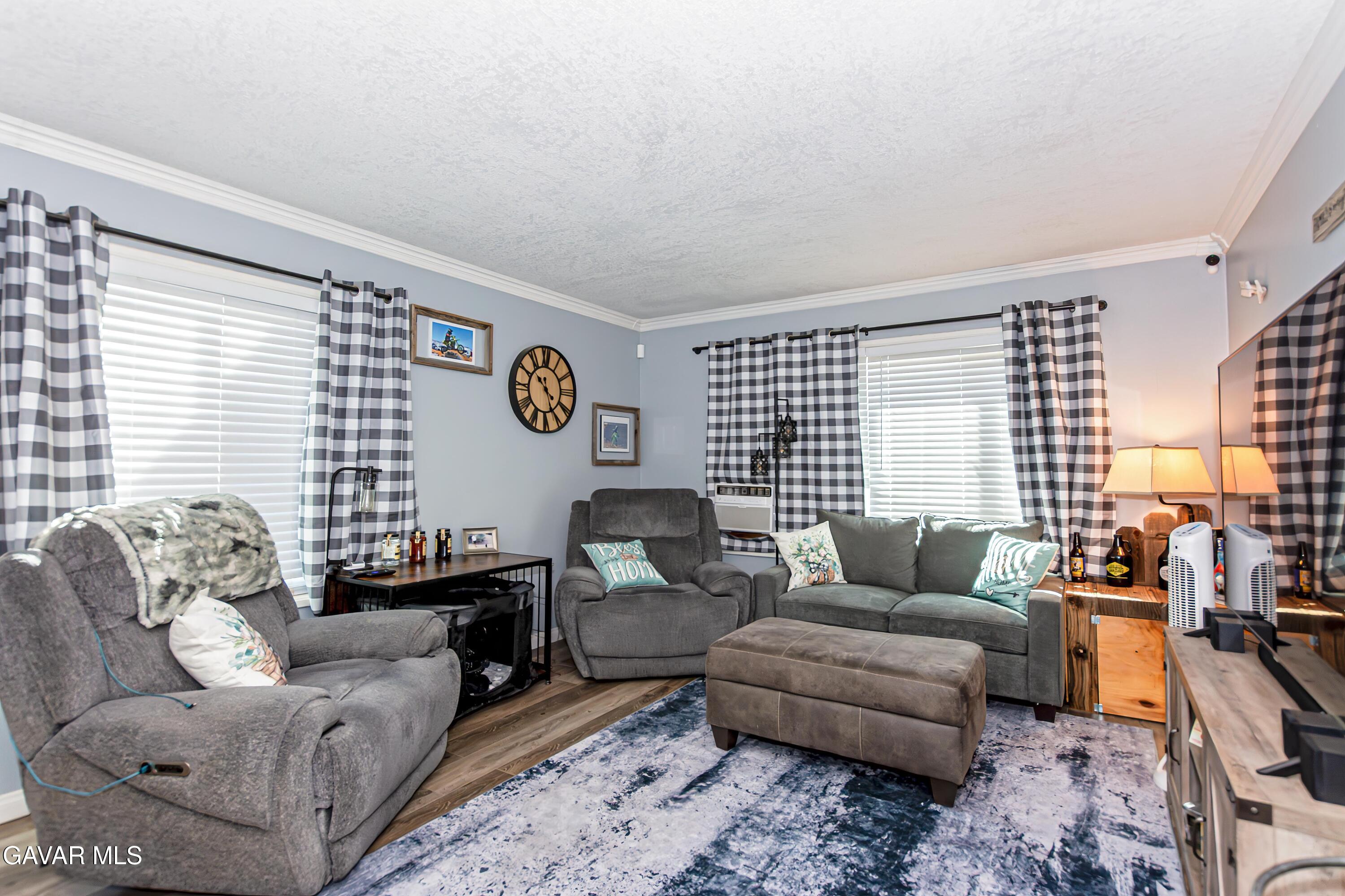 42933 Alexo Drive Lancaster, CA 93536 - Photo 6 of 32 a living room with furniture and large windows