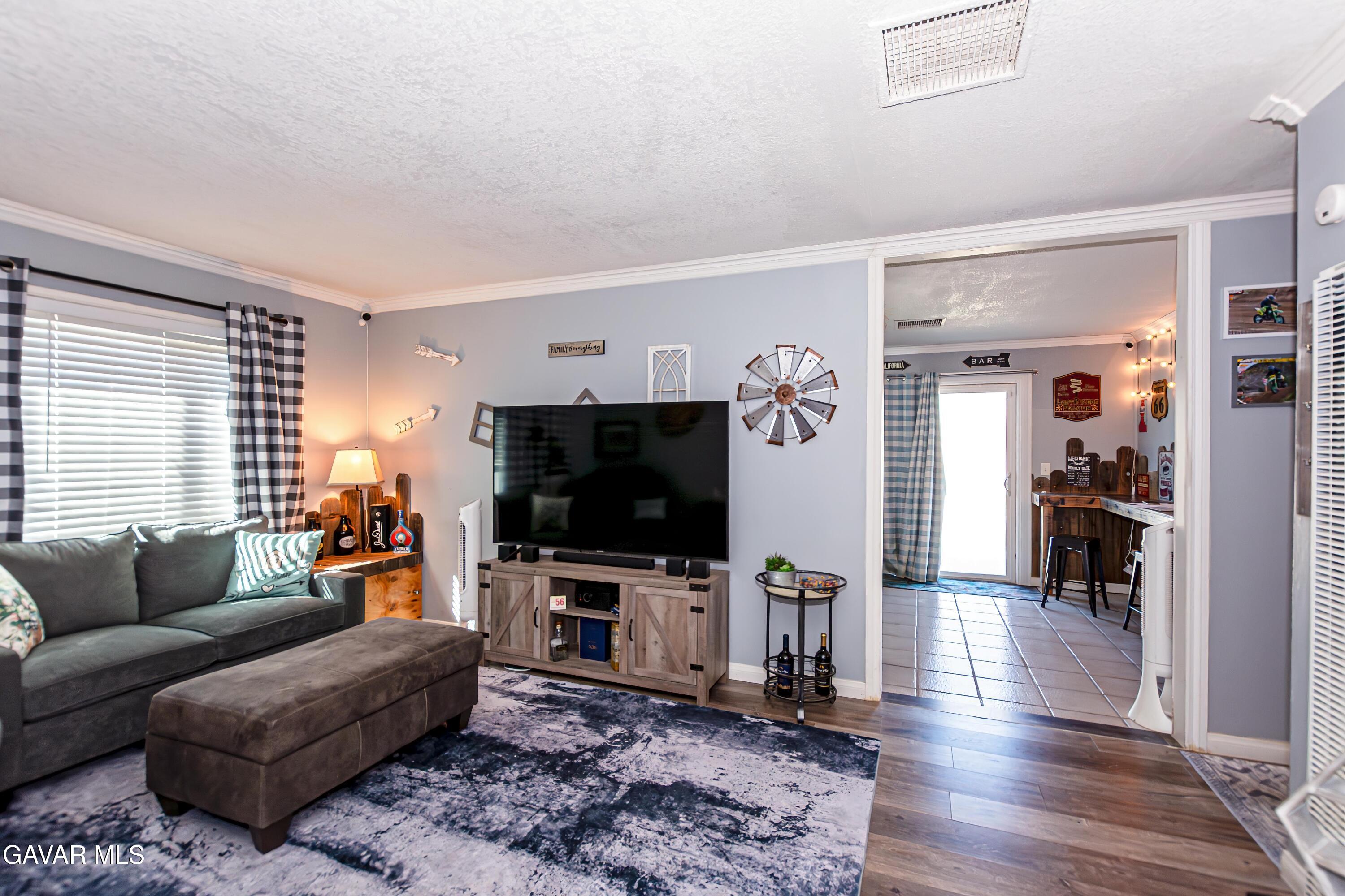 42933 Alexo Drive Lancaster, CA 93536 - Photo 8 of 32 a living room with furniture and a flat screen tv