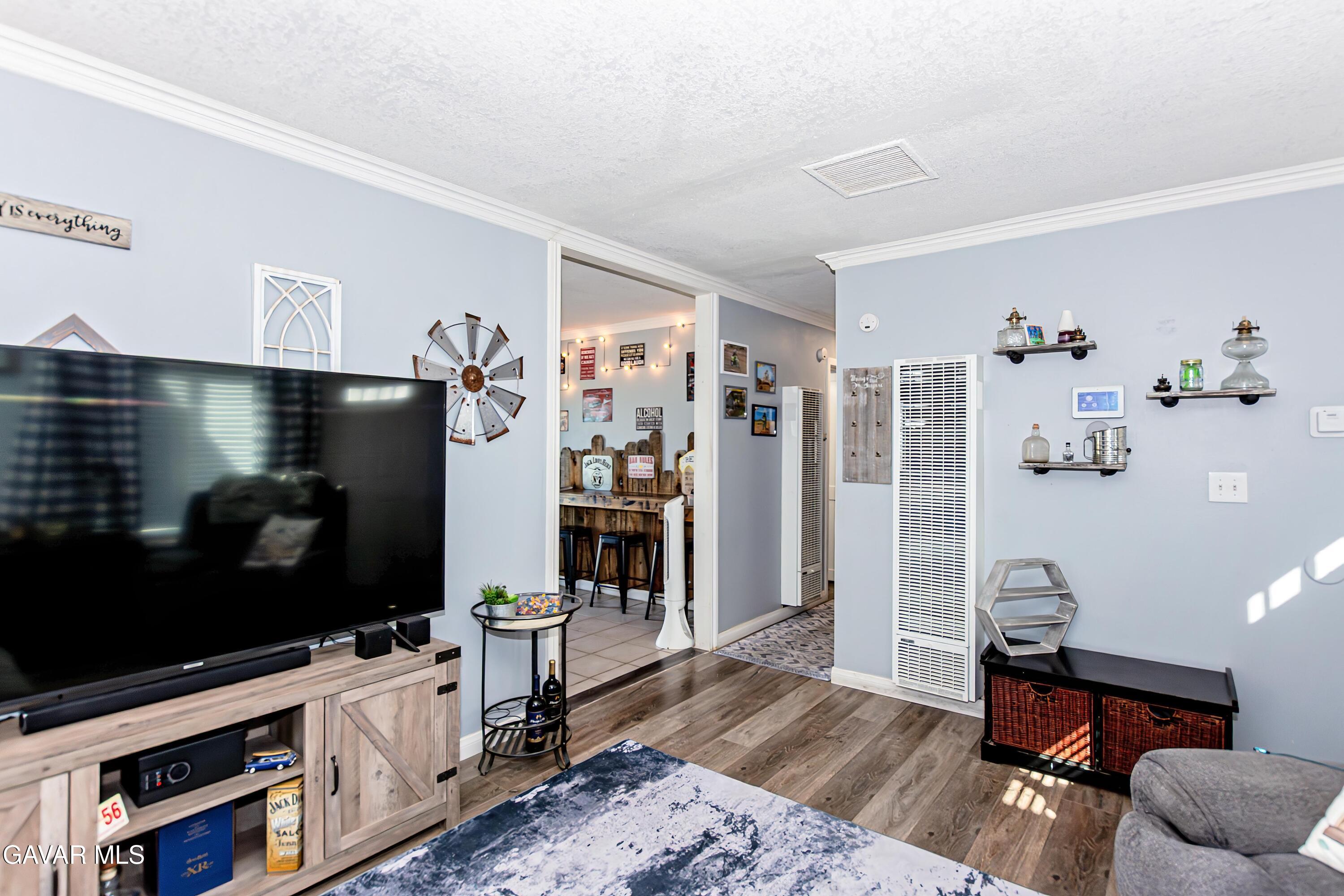 42933 Alexo Drive Lancaster, CA 93536 - Photo 10 of 32 a living room with furniture flat screen tv and wooden floor