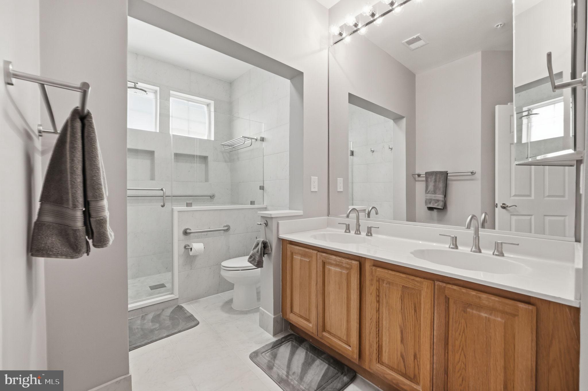 7023 Haycock Road Falls Church, VA 22043 - Photo 18 of 22 a bathroom with a double vanity sink and mirror