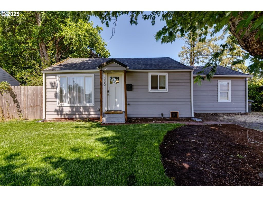 320 26th Street Springfield, OR 97477 - Photo 1 of 24 a view of a house with a yard and a large tree