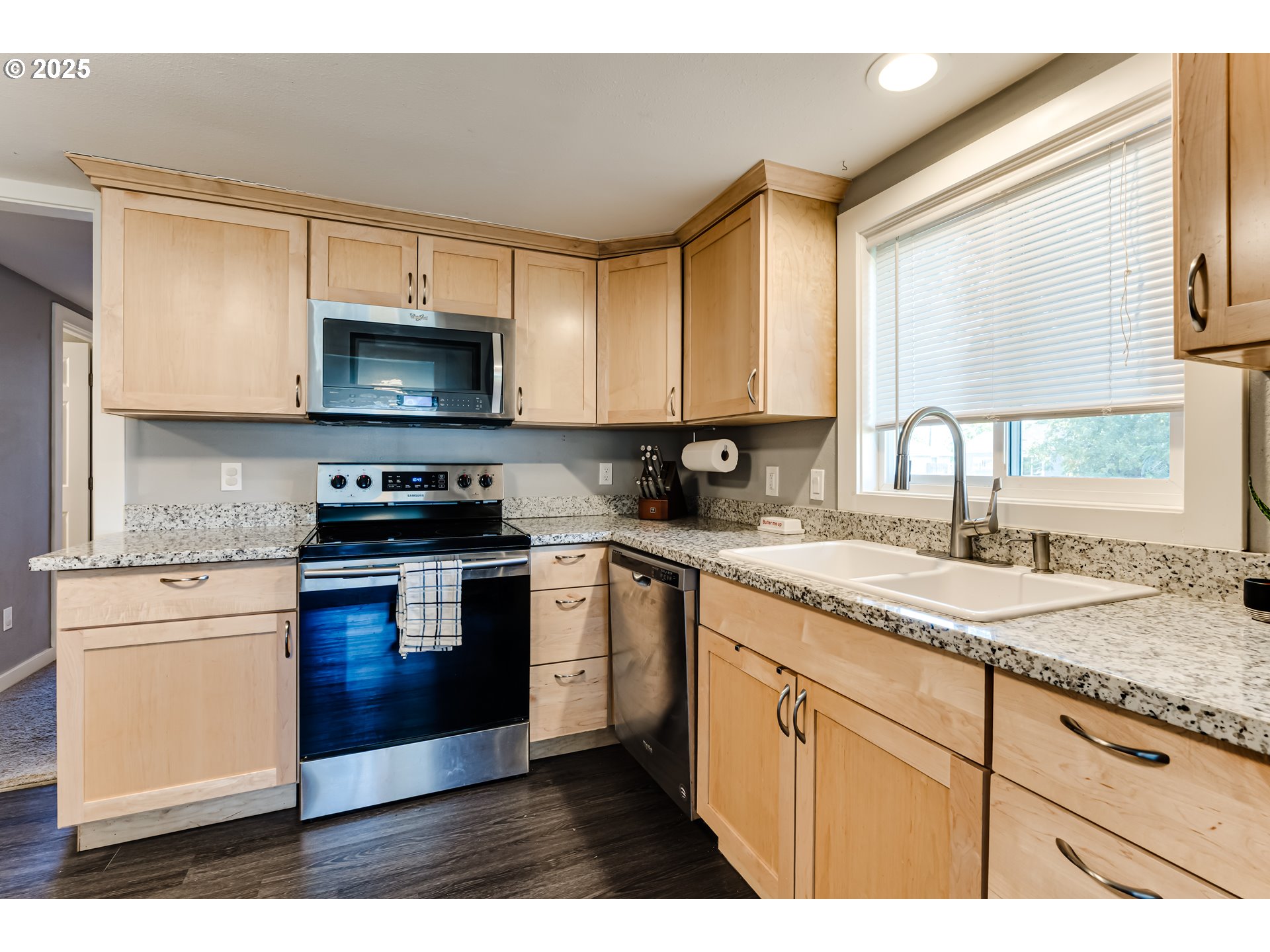 320 26th Street Springfield, OR 97477 - Photo 5 of 24 a kitchen with granite countertop a stove a sink and a microwave
