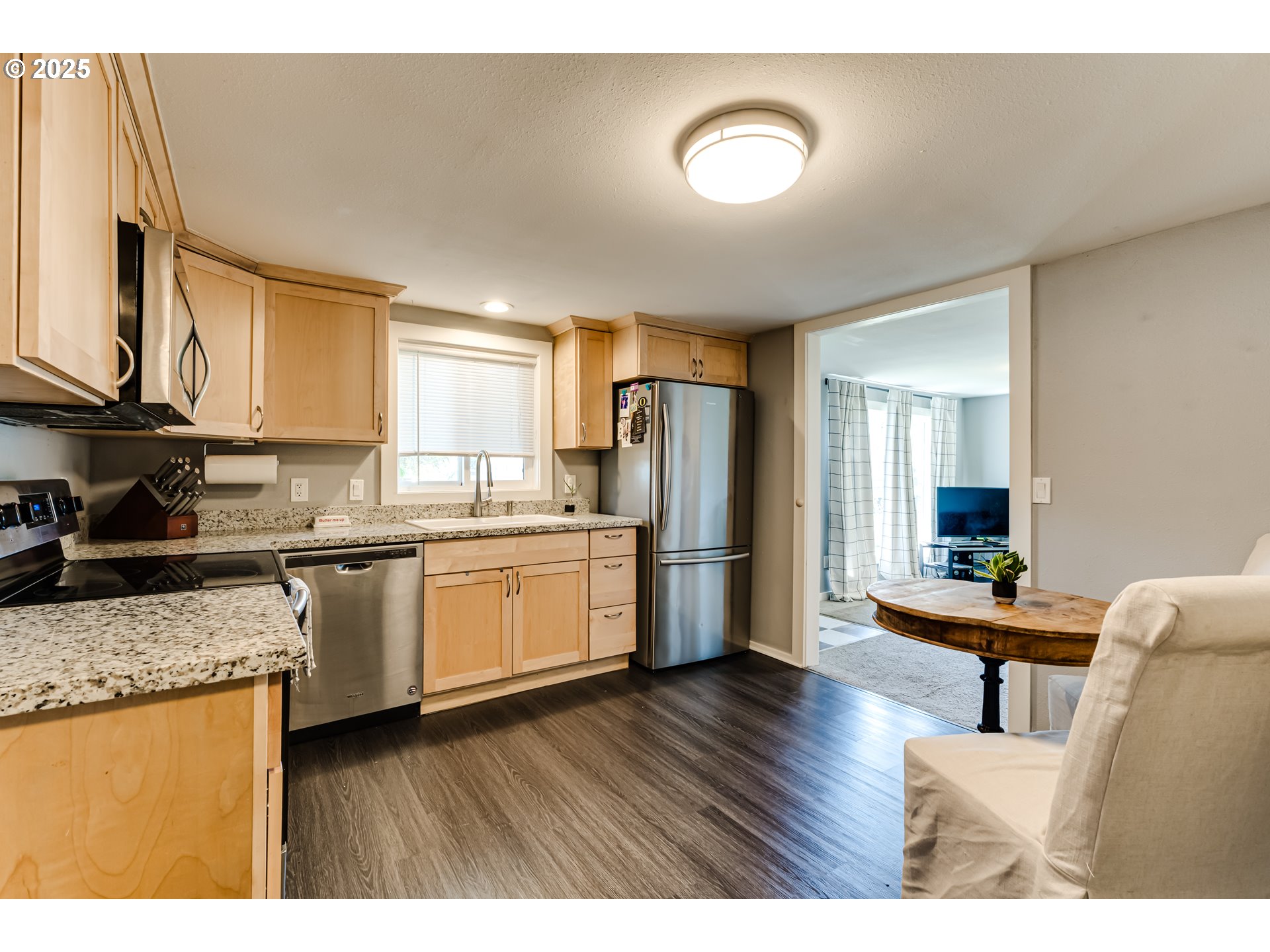 320 26th Street Springfield, OR 97477 - Photo 6 of 24 a kitchen with stainless steel appliances granite countertop a refrigerator a sink dishwasher a stove with wooden cabinets and floor