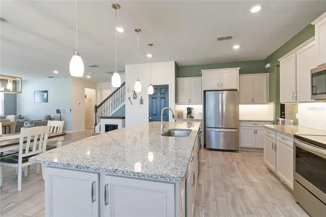 a utility room with sink dryer and washer