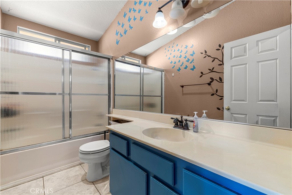 15417 Tobarra Road Fontana, CA 92337 - Photo 21 of 29 a bathroom with a sink vanity granite toilet and shower