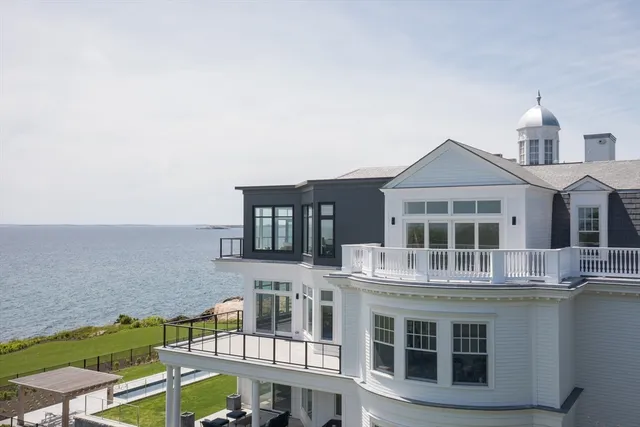 a front view of a house with yard and trees