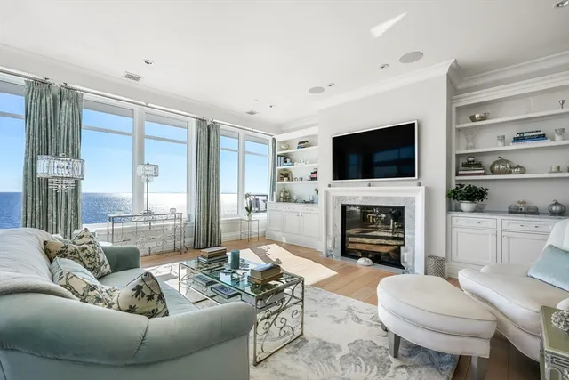 a living room with furniture a flat screen tv and a fireplace