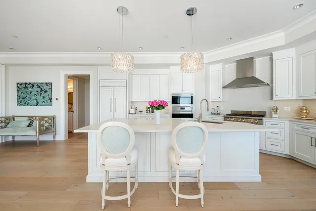 a kitchen with stainless steel appliances granite countertop a stove a sink and a refrigerator