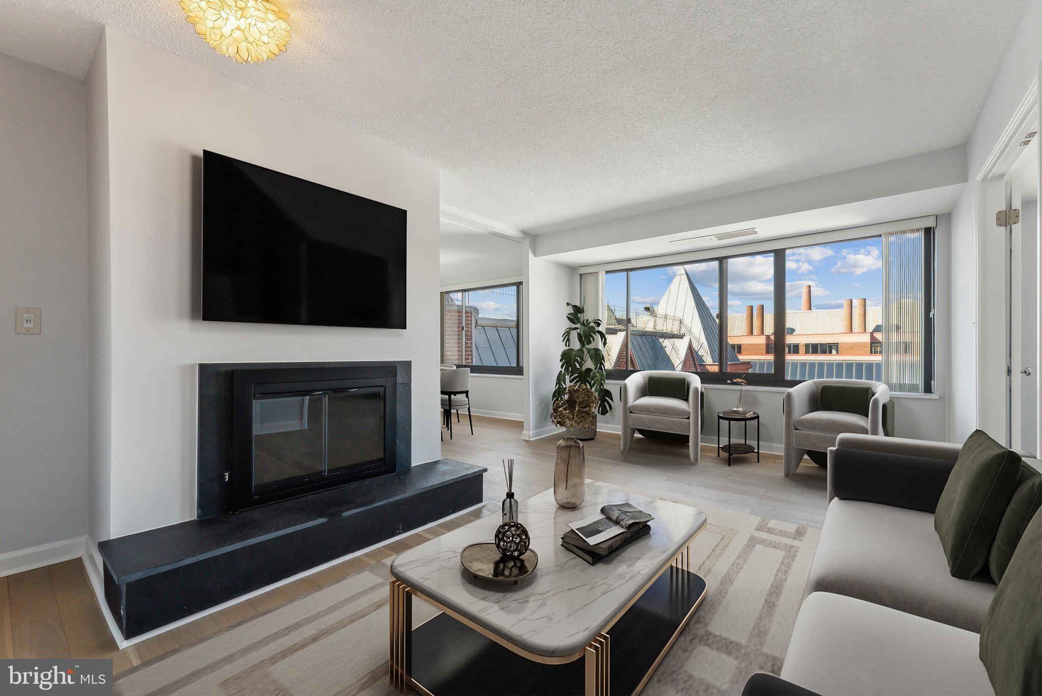 a living room with furniture a fireplace and a flat screen tv