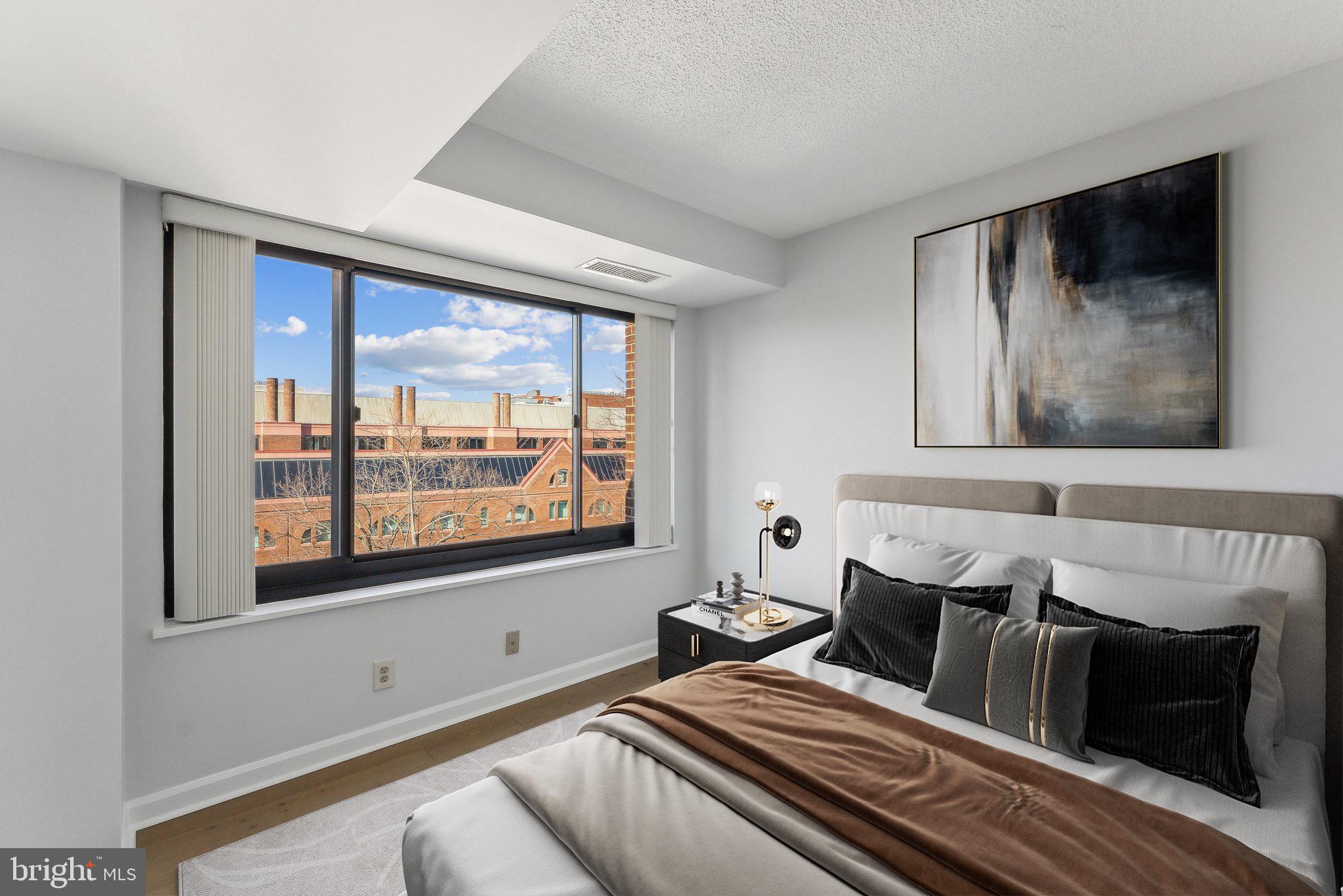 1077 30th Street Northwest, Unit 705 Washington, DC 20007 - Photo 11 of 31 a bedroom with a bed and a large window