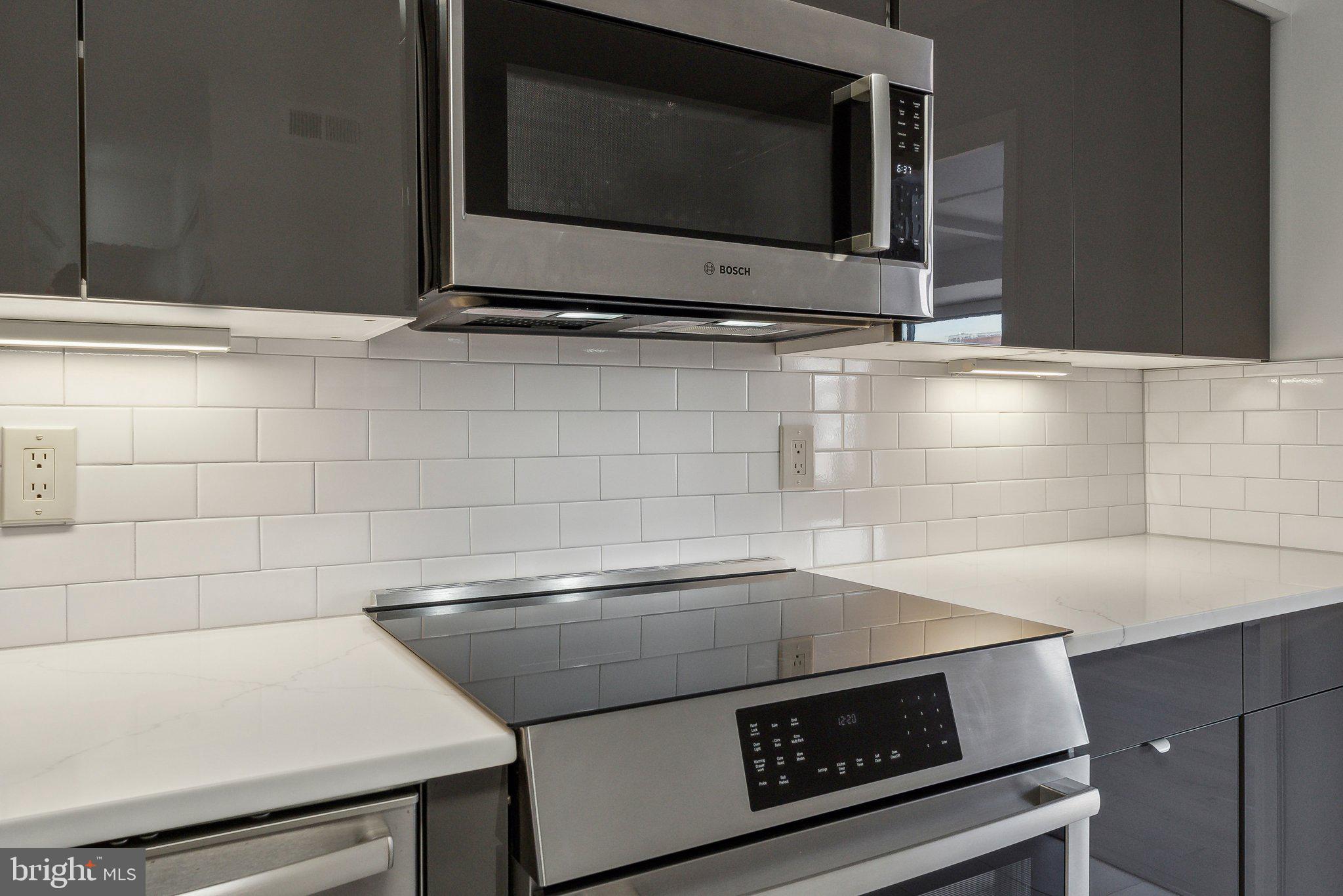 1077 30th Street Northwest, Unit 705 Washington, DC 20007 - Photo 17 of 31 a kitchen with a stove microwave and sink