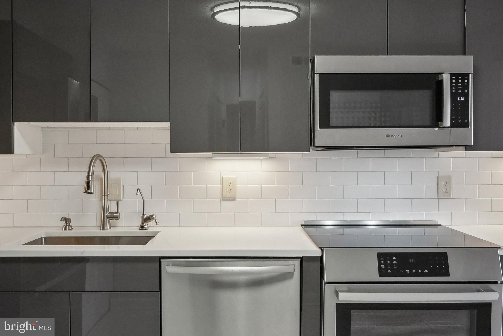 1077 30th Street Northwest, Unit 705 Washington, DC 20007 - Photo 18 of 31 a kitchen with a stove and a microwave