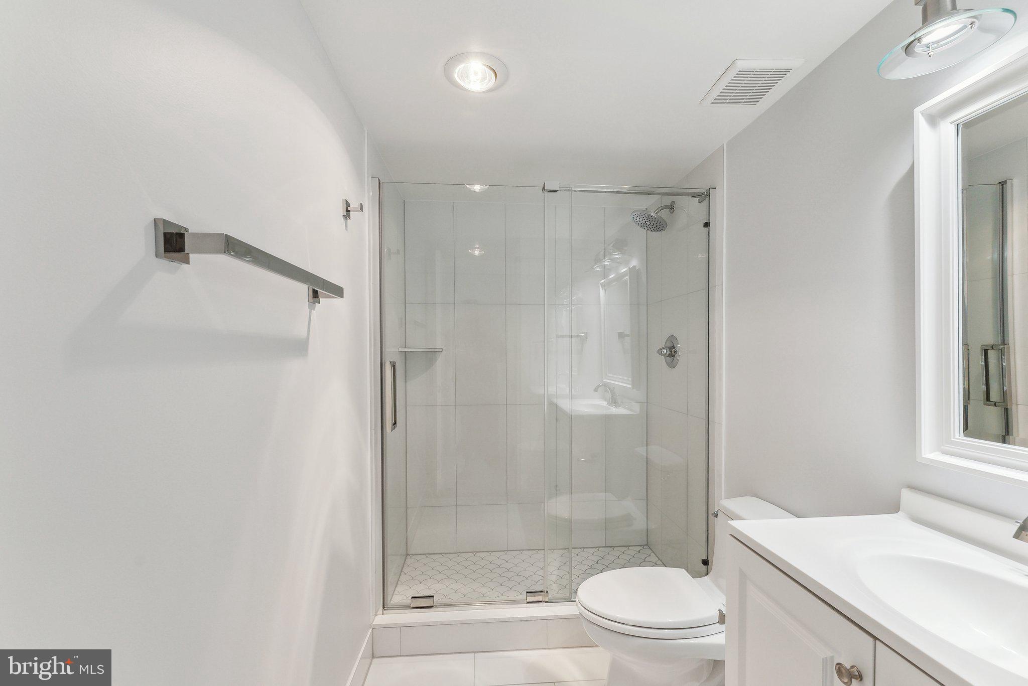 1077 30th Street Northwest, Unit 705 Washington, DC 20007 - Photo 21 of 31 a bathroom with a shower a toilet and a sink