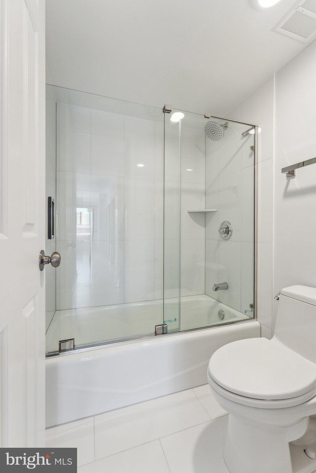 1077 30th Street Northwest, Unit 705 Washington, DC 20007 - Photo 23 of 31 a bathroom with a bathtub and shower