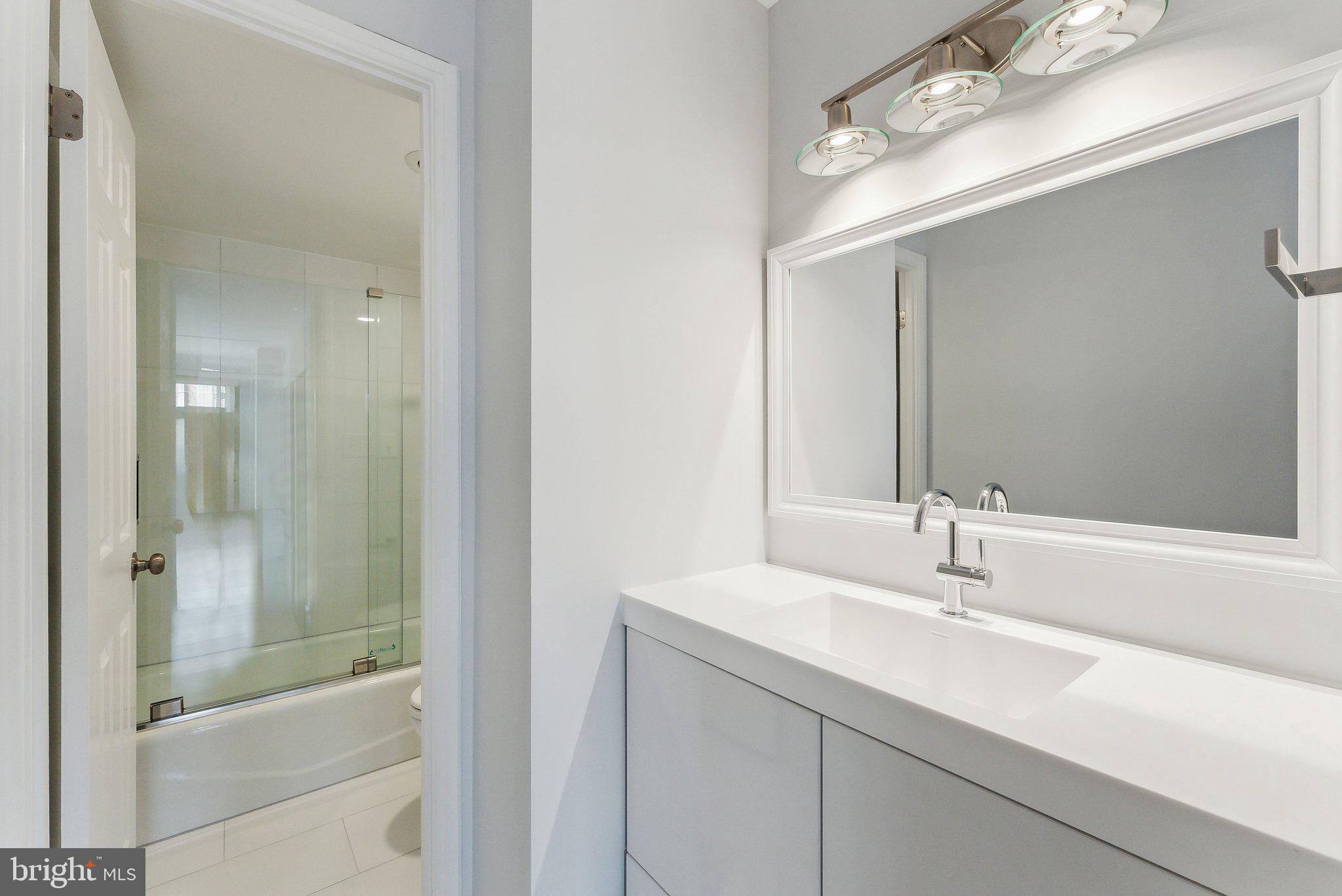 1077 30th Street Northwest, Unit 705 Washington, DC 20007 - Photo 25 of 31 a bathroom with a sink and a mirror