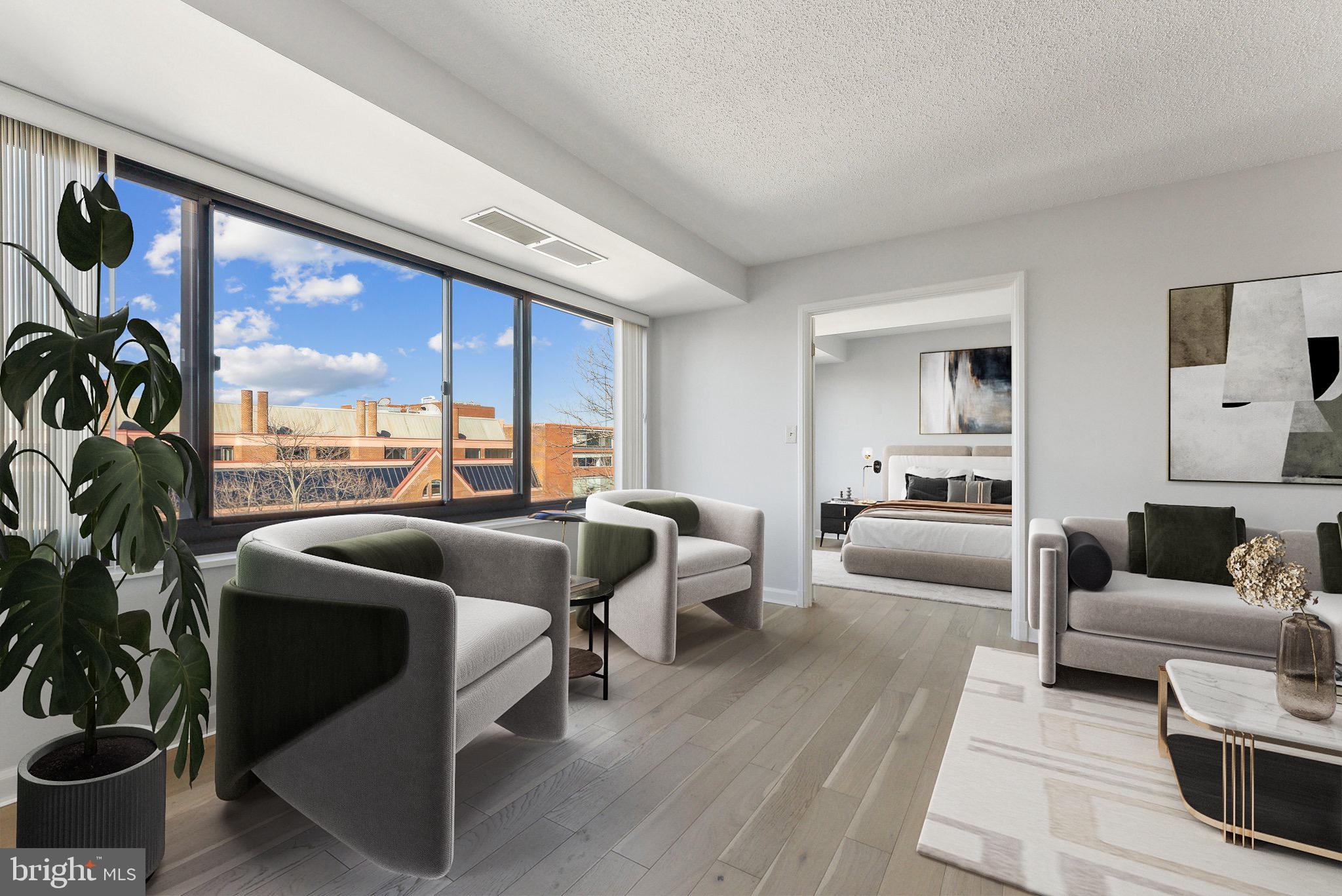 1077 30th Street Northwest, Unit 705 Washington, DC 20007 - Photo 3 of 31 a living room with furniture and a large window
