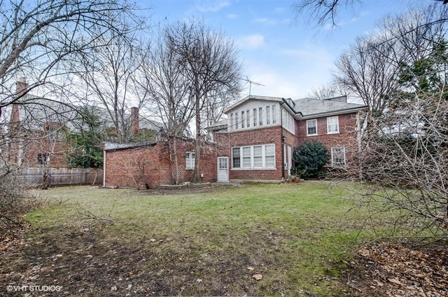 240 Raleigh Road Kenilworth, IL 60043 - Photo 3 of 9 a view of a house with a yard and garage