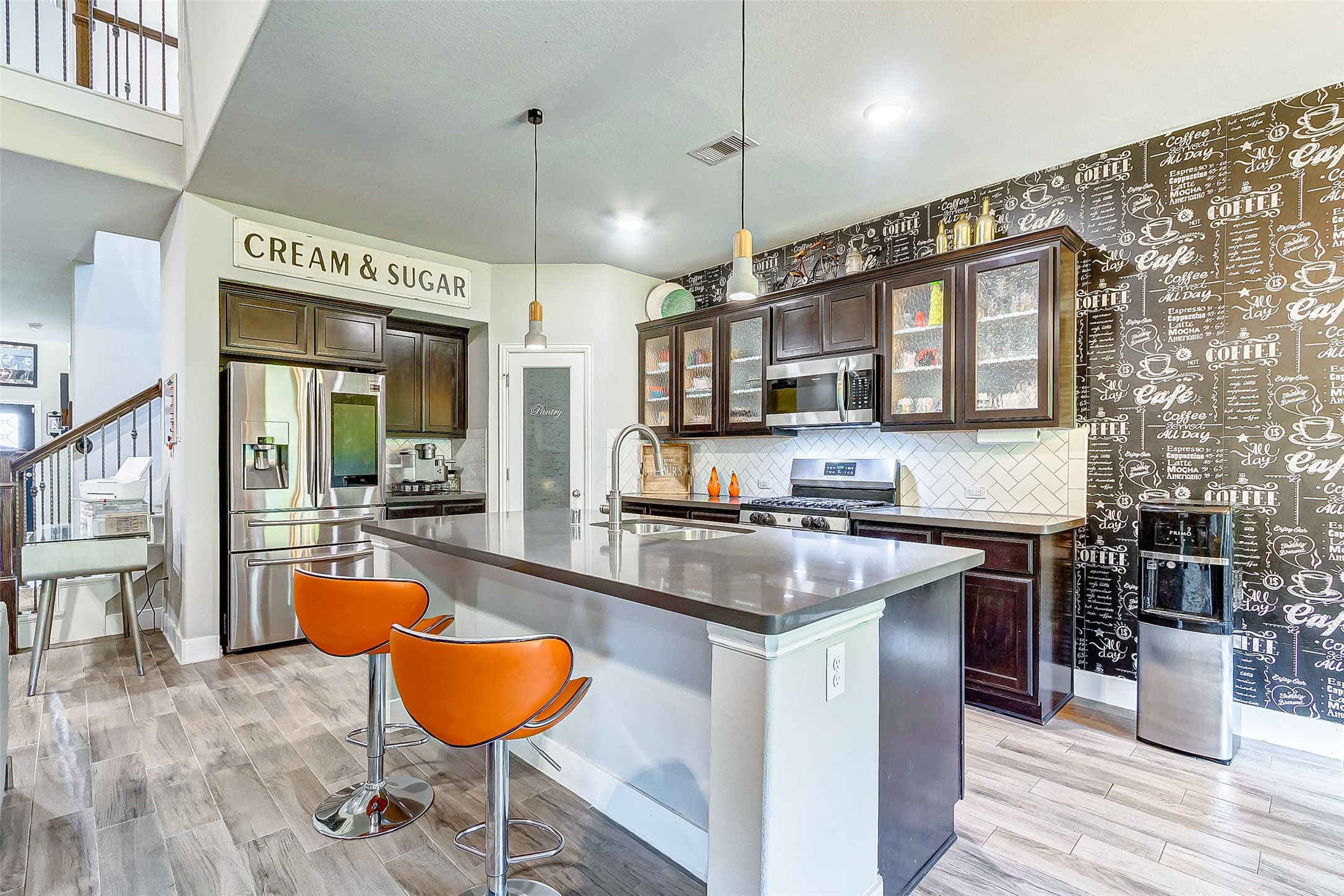 7314 Saddle Tree Drive Spring, TX 77379 - Photo 2 of 21 a kitchen with stainless steel appliances granite countertop a stove refrigerator and cabinets