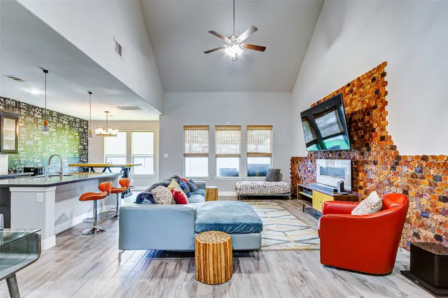 a living room with furniture fireplace and flat screen tv