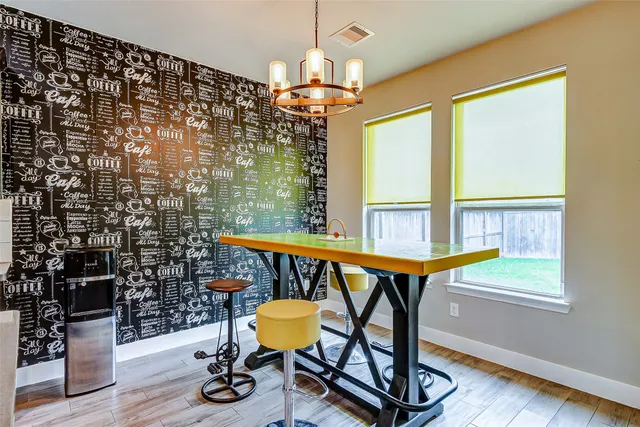 a dining room with furniture and wooden floor