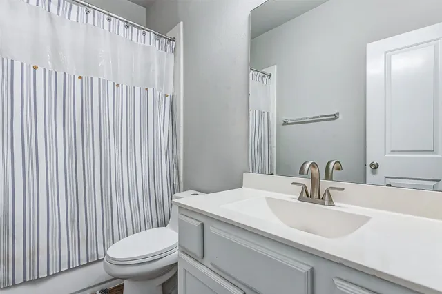 a bedroom with bed and large windows