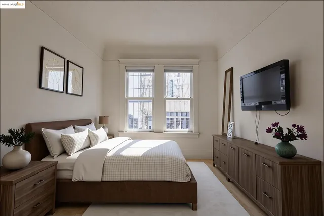 a bedroom with bed tv and window