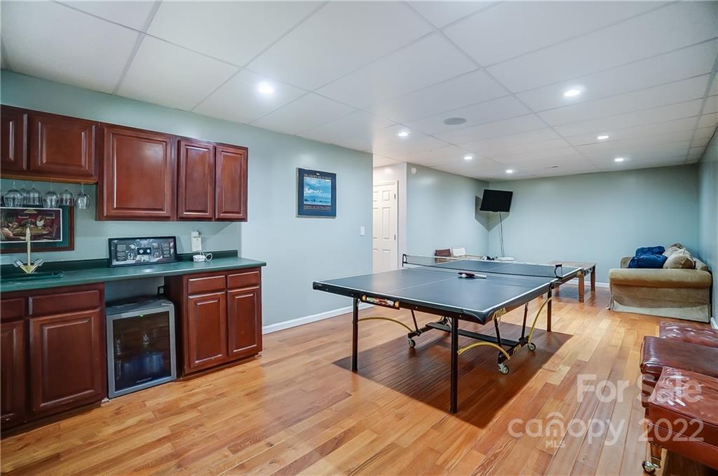 31020 Executive Point Tega Cay, SC 29708 - Photo 33 of 48 a kitchen with stainless steel appliances granite countertop a sink dishwasher a stove with wooden cabinets and floor