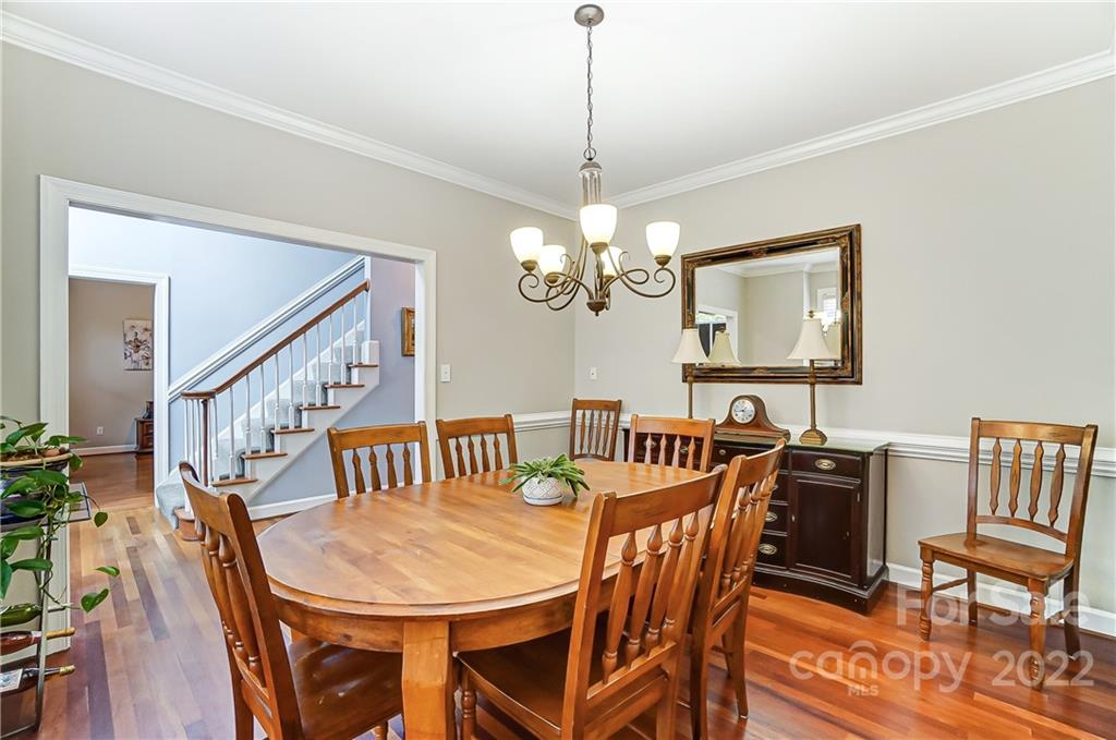 31020 Executive Point Tega Cay, SC 29708 - Photo 6 of 48 a view of a dining room with furniture wooden floor and chandelier