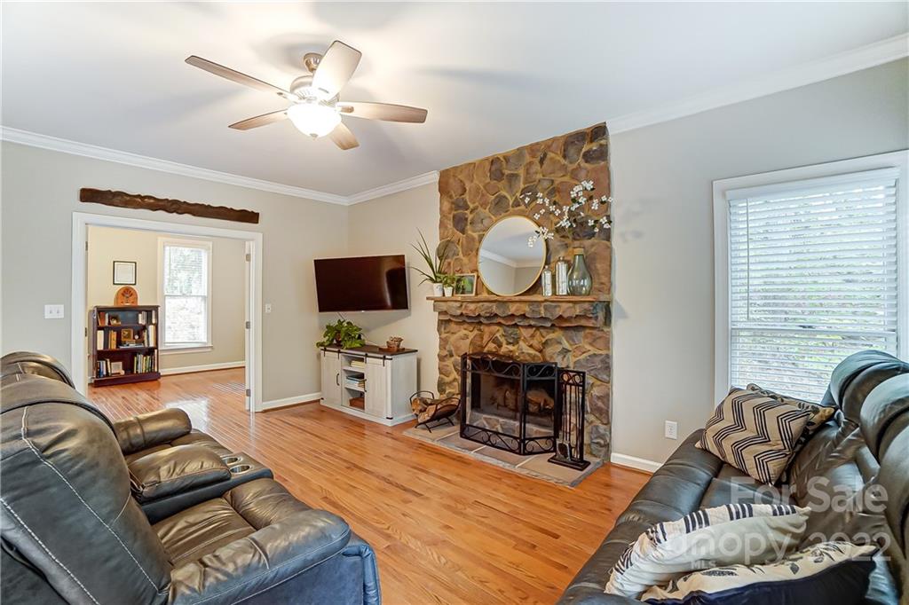31020 Executive Point Tega Cay, SC 29708 - Photo 10 of 48 a living room with furniture a flat screen tv and a fireplace