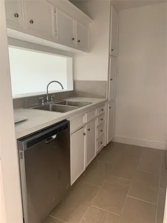 a kitchen with a sink and cabinets