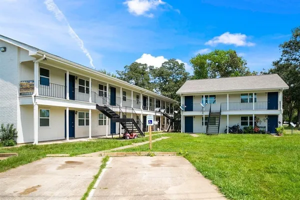 a front view of a building with a garden