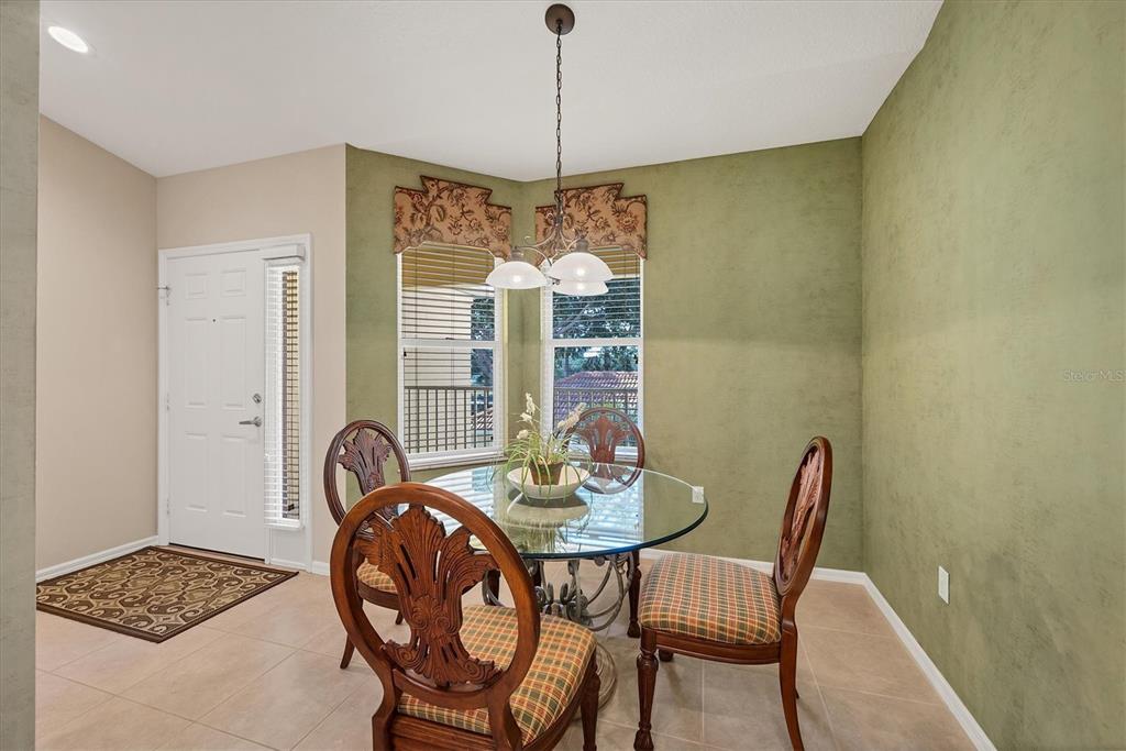 7115 Boca Grove Place, Unit 204 Lakewood Ranch, FL 34202 - Photo 14 of 40 a dining room with furniture and window