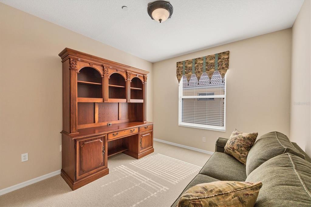 7115 Boca Grove Place, Unit 204 Lakewood Ranch, FL 34202 - Photo 16 of 40 a living room with furniture cabinets and a window