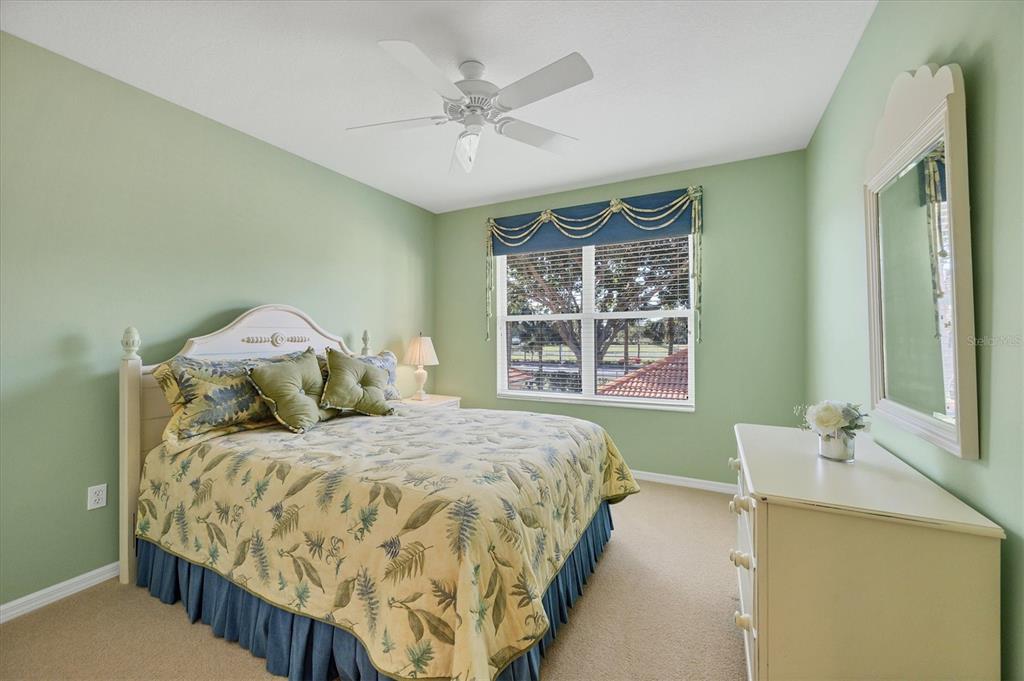 7115 Boca Grove Place, Unit 204 Lakewood Ranch, FL 34202 - Photo 21 of 40 a bedroom with a bed and window