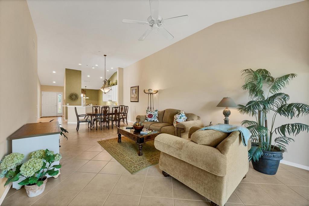 7115 Boca Grove Place, Unit 204 Lakewood Ranch, FL 34202 - Photo 7 of 40 a living room with furniture and a potted plant