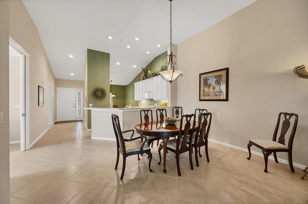 7115 Boca Grove Place, Unit 204 Lakewood Ranch, FL 34202 - Photo 8 of 40 a view of a dining room with furniture