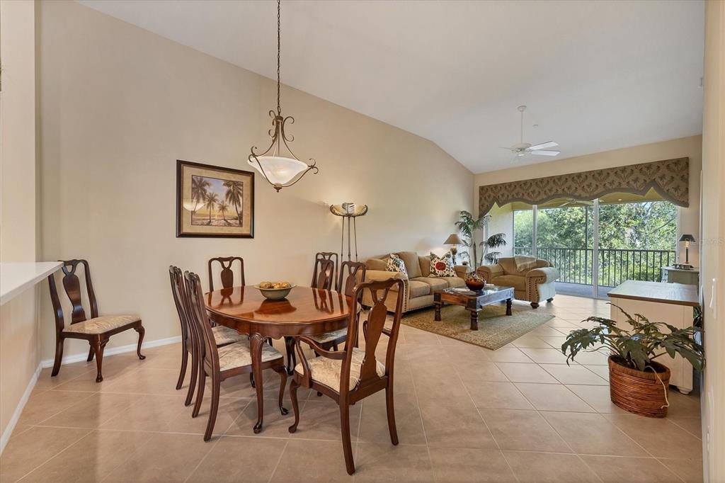 7115 Boca Grove Place, Unit 204 Lakewood Ranch, FL 34202 - Photo 9 of 40 a view of a dining room and hall with furniture