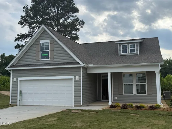 a house that has a tree in front of it