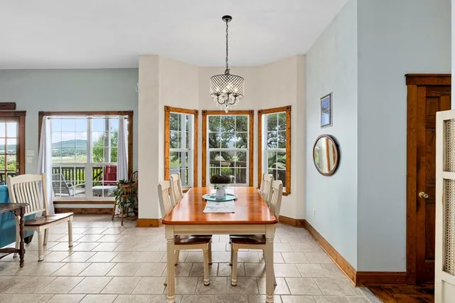 a living room with furniture a window and a chandelier