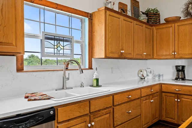 a kitchen with sink cabinets and window