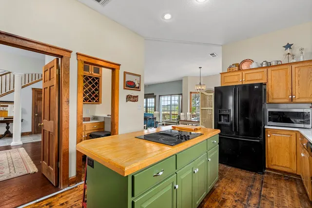 a kitchen with a refrigerator and a stove