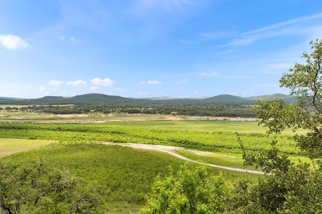 a view of chairs and table in patio with wooden floor