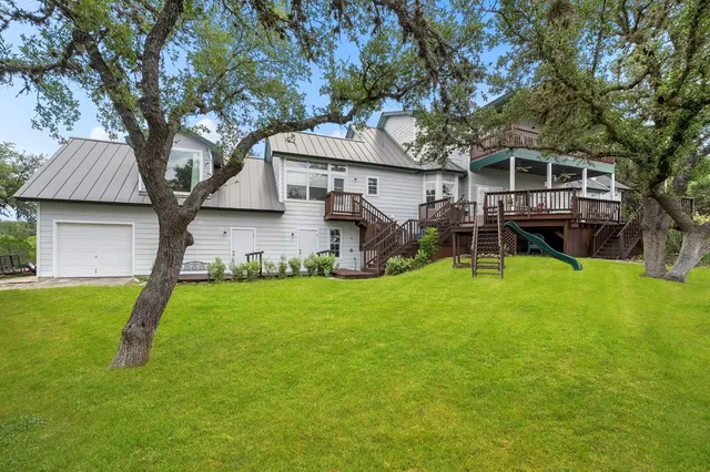 a backyard of a house with table and chairs