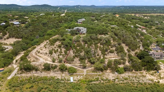 a view of a yard with wooden fence