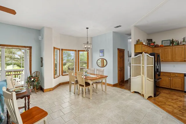 a living room with furniture a window and wooden floor