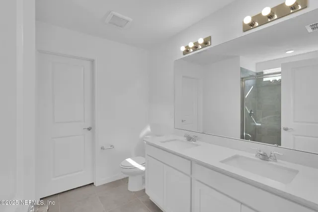 a bathroom with a glass shower door
