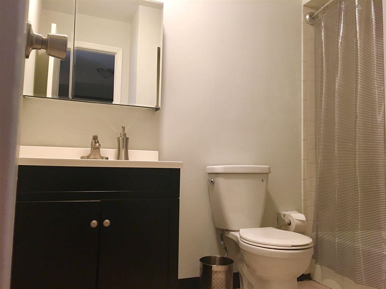 226 Christopher Columbus Drive, Unit 1 Jersey City, NJ 07302 - Photo 5 of 8 a bathroom with a sink and a toilet